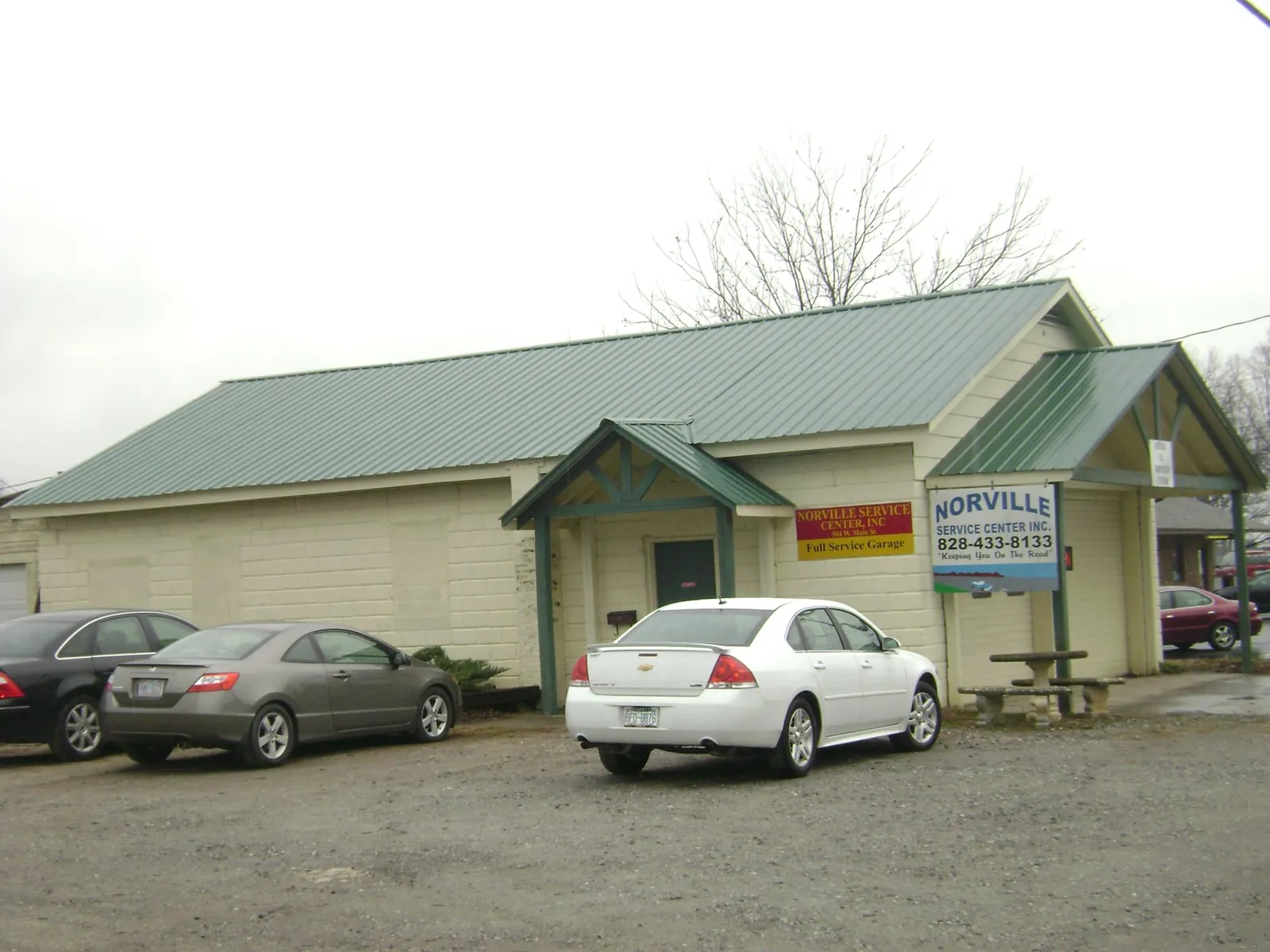 Green metal roof on a service garage with a covered entry in Findlay